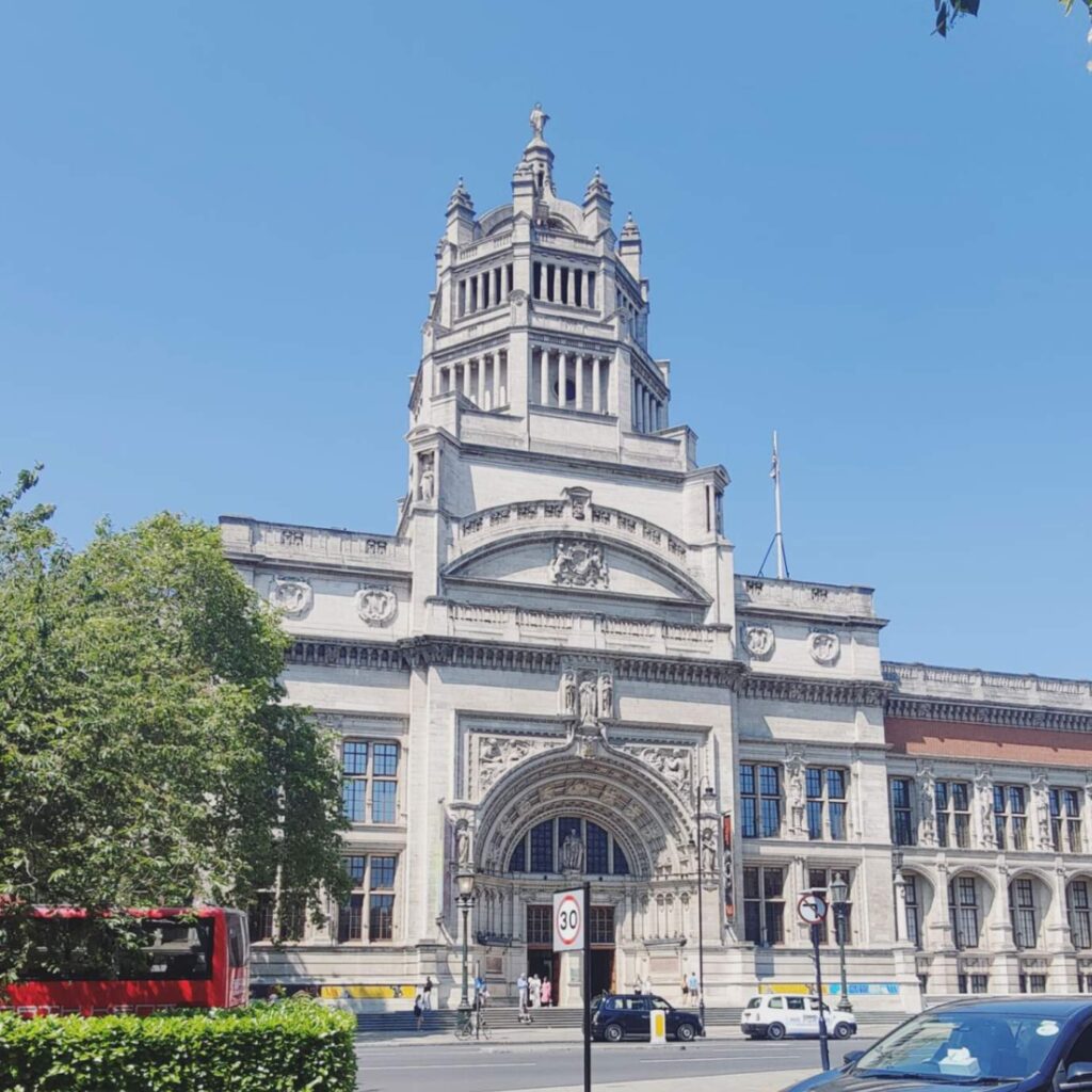 Ornate Victorian building with a central tower on a sunny London street