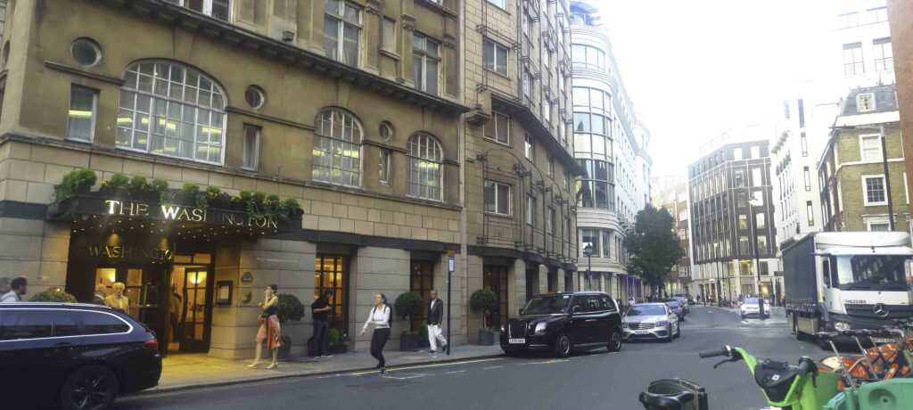 Hotel entrance with arched windows on a quiet London street