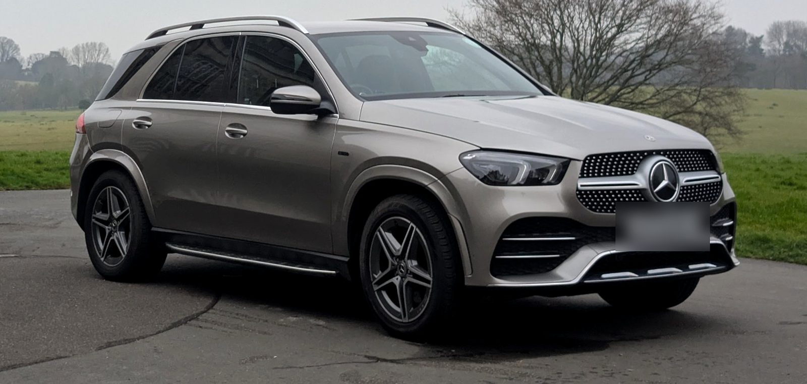 Champagne Mercedes GLE SUV parked on a quiet road
