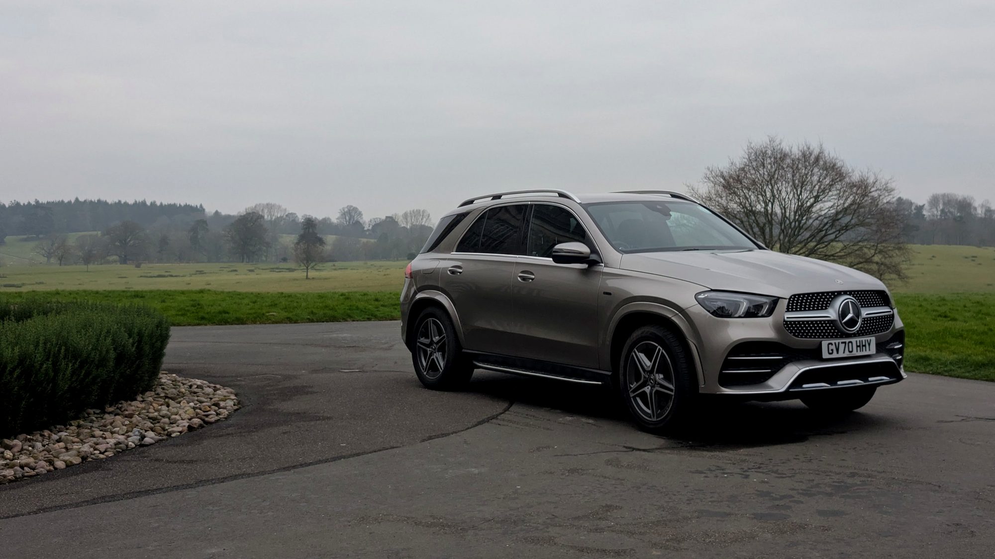 Champagne Mercedes GLE SUV parked on a quiet road